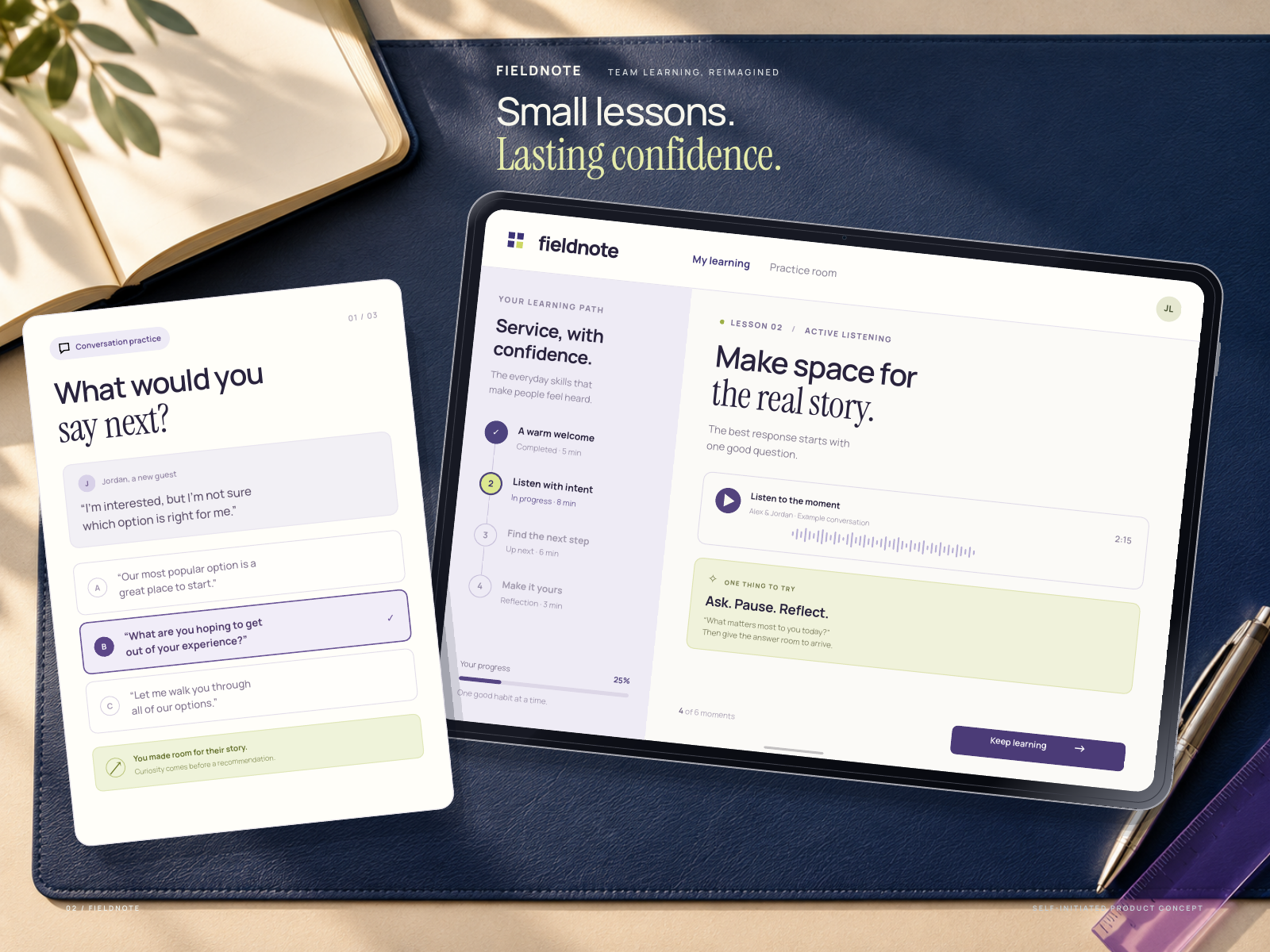 An angled learning-path tablet and scenario-practice response card on an indigo leather desk mat beside a notebook and chrome pen.